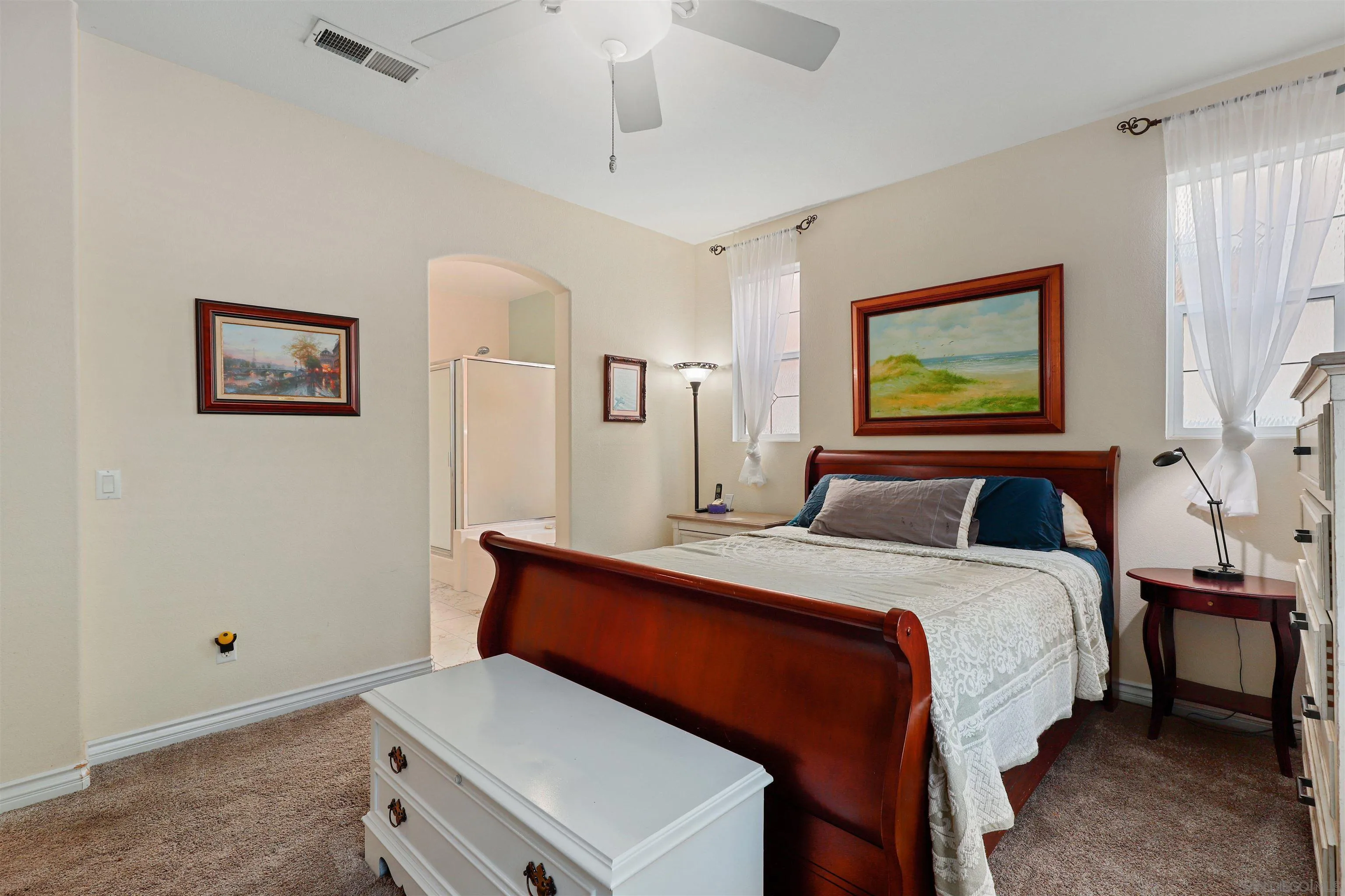 554 Poets Square Fallbrook, CA 92028 - Photo 12 of 28 a bedroom with a bed and a painting on the wall