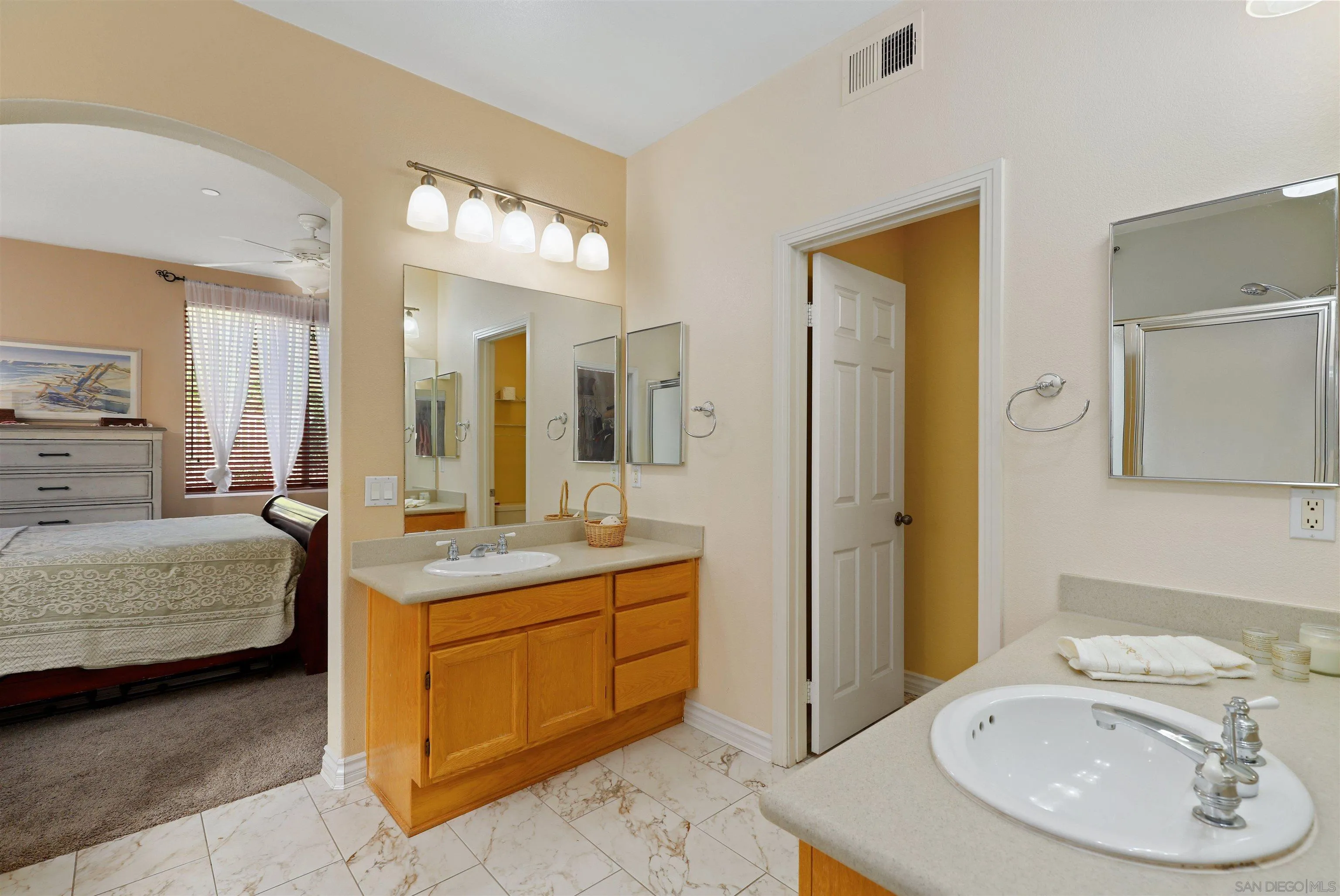 554 Poets Square Fallbrook, CA 92028 - Photo 13 of 28 a en suite bathroom with a double vanity sink and a mirror
