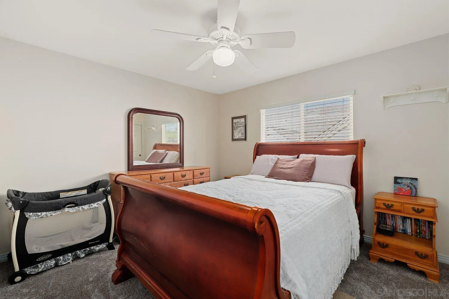 554 Poets Square Fallbrook, CA 92028 - Photo 19 of 28 a bedroom with a bed and a chandelier