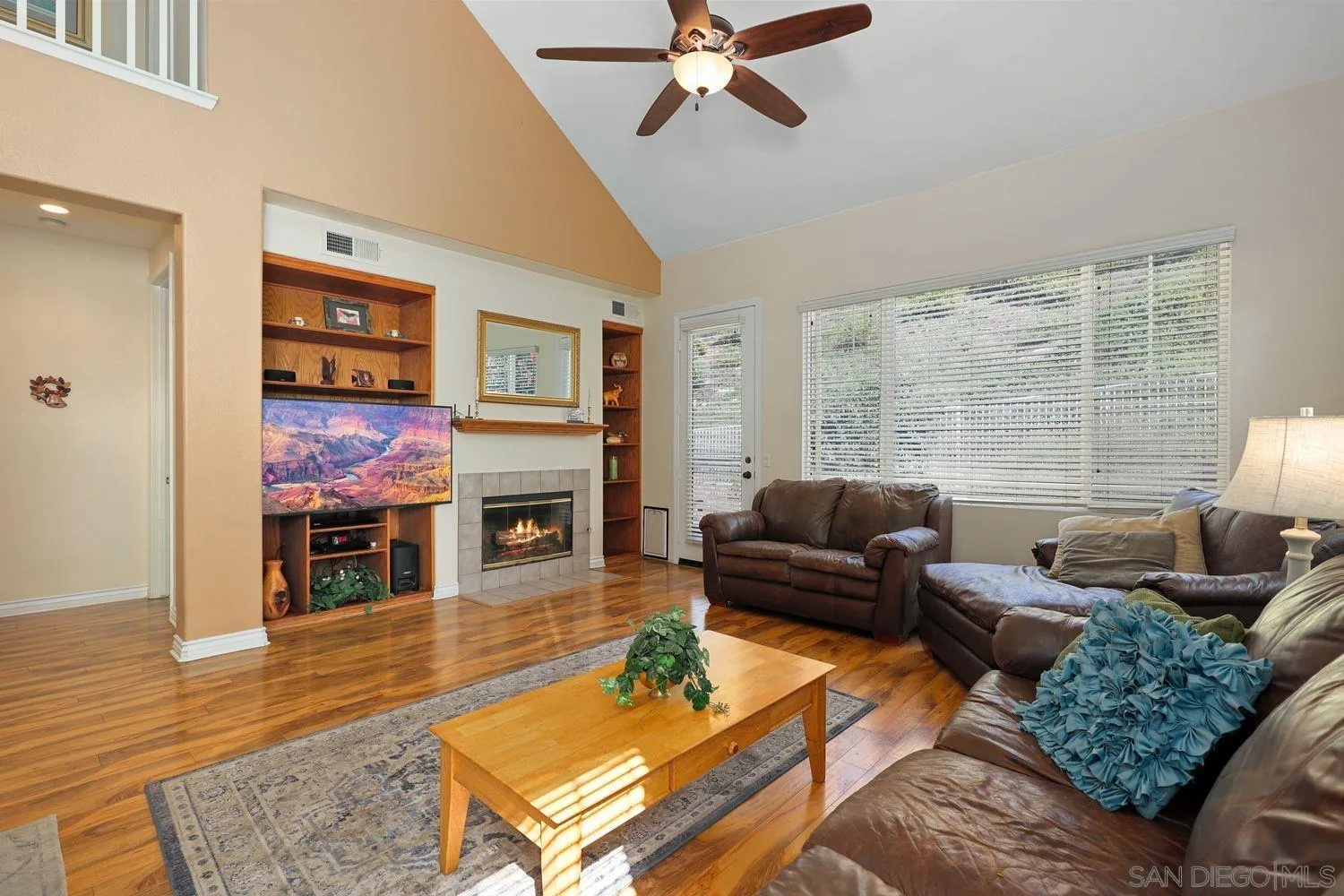 554 Poets Square Fallbrook, CA 92028 - Photo 5 of 28 a living room with furniture fireplace and a large window