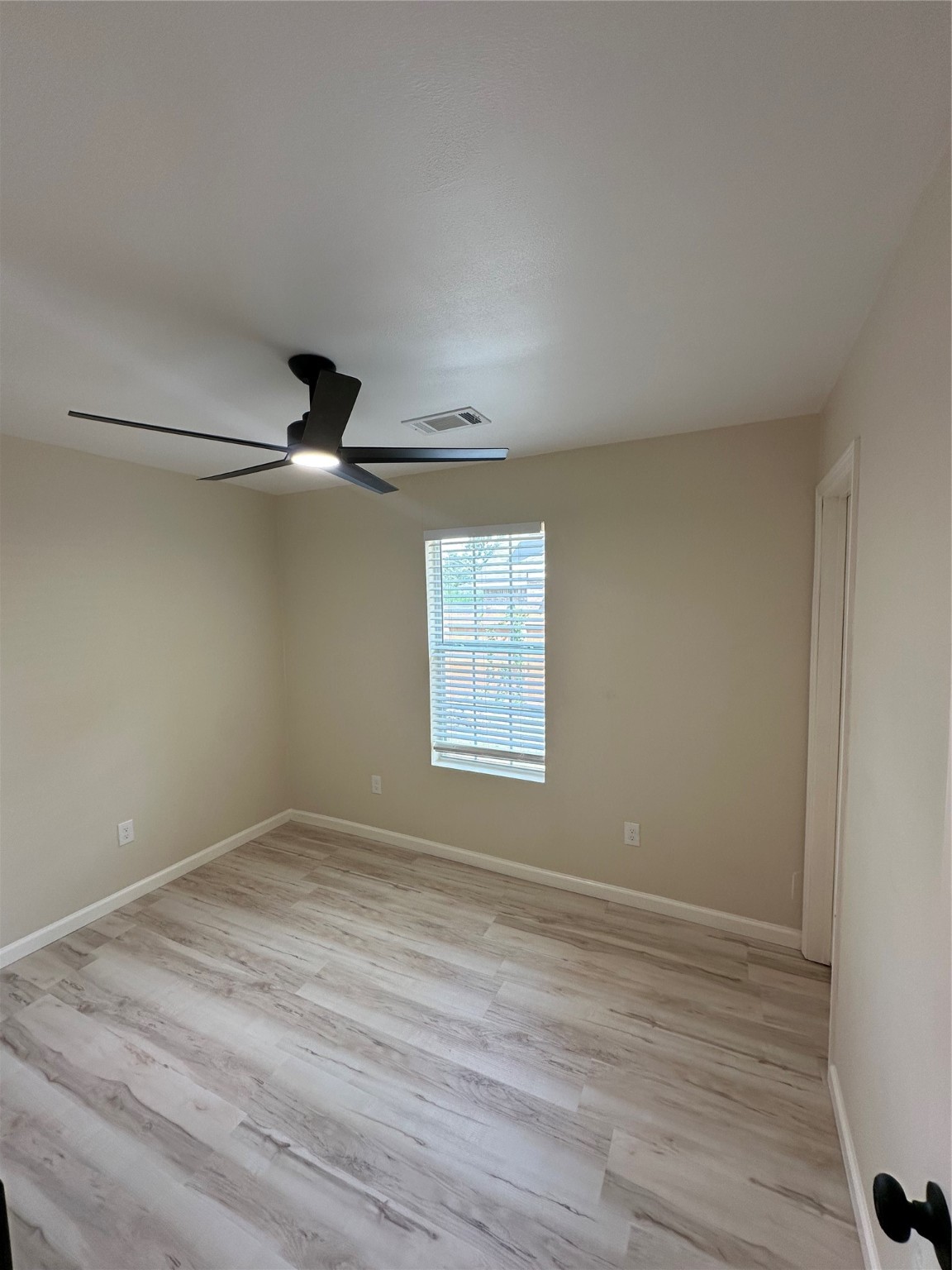 5910 East Houston Road Houston, TX 77028 - Photo 12 of 33 a view of an empty room with wooden floor and a window