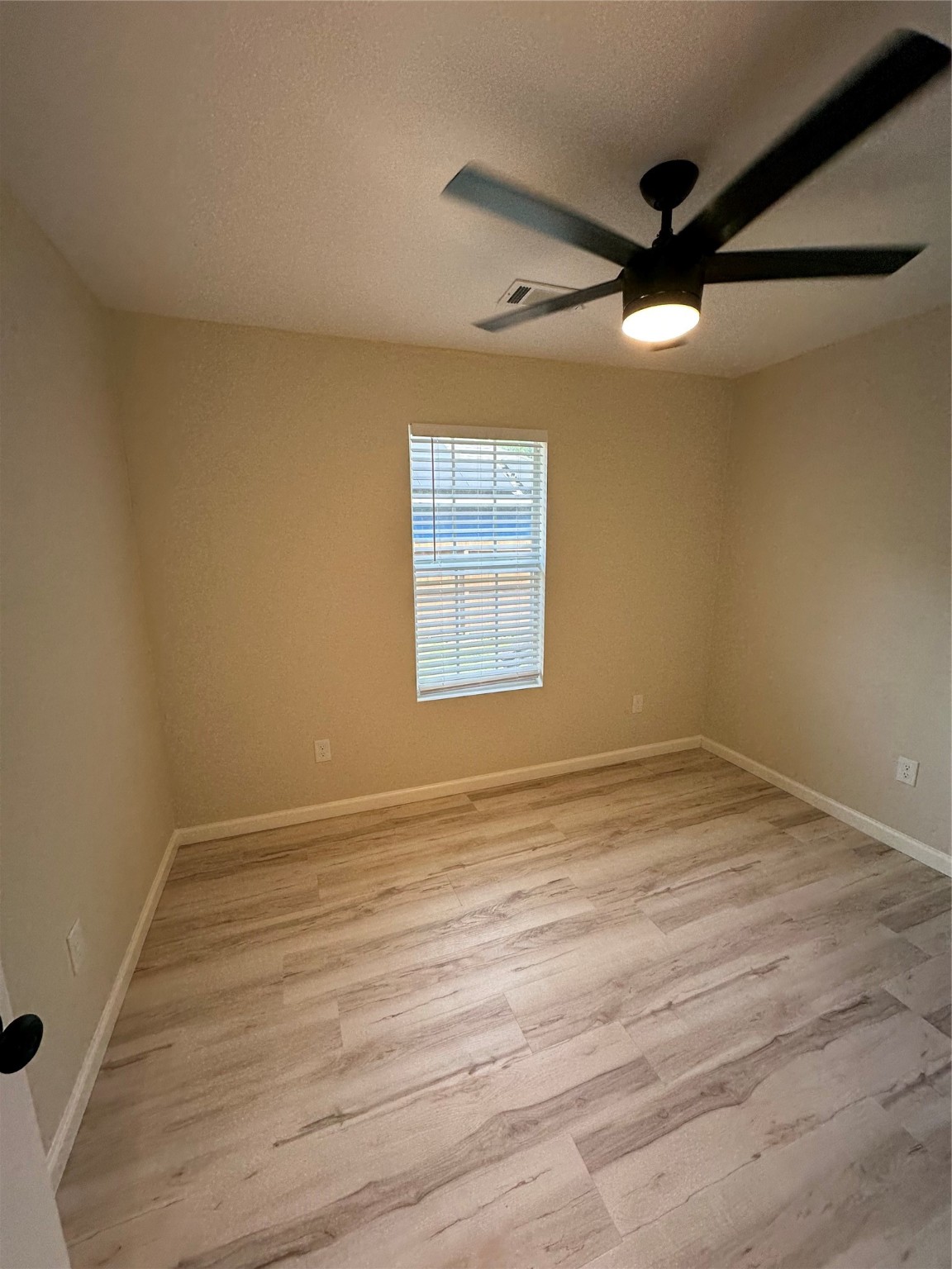 5910 East Houston Road Houston, TX 77028 - Photo 13 of 33 an empty room with a window and a ceiling fan