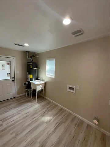 a view of a room with furniture window and wooden floor