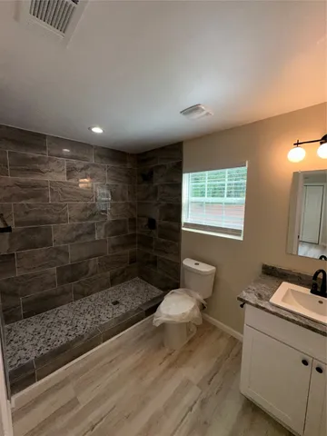 a bathroom with a sink toilet and shower