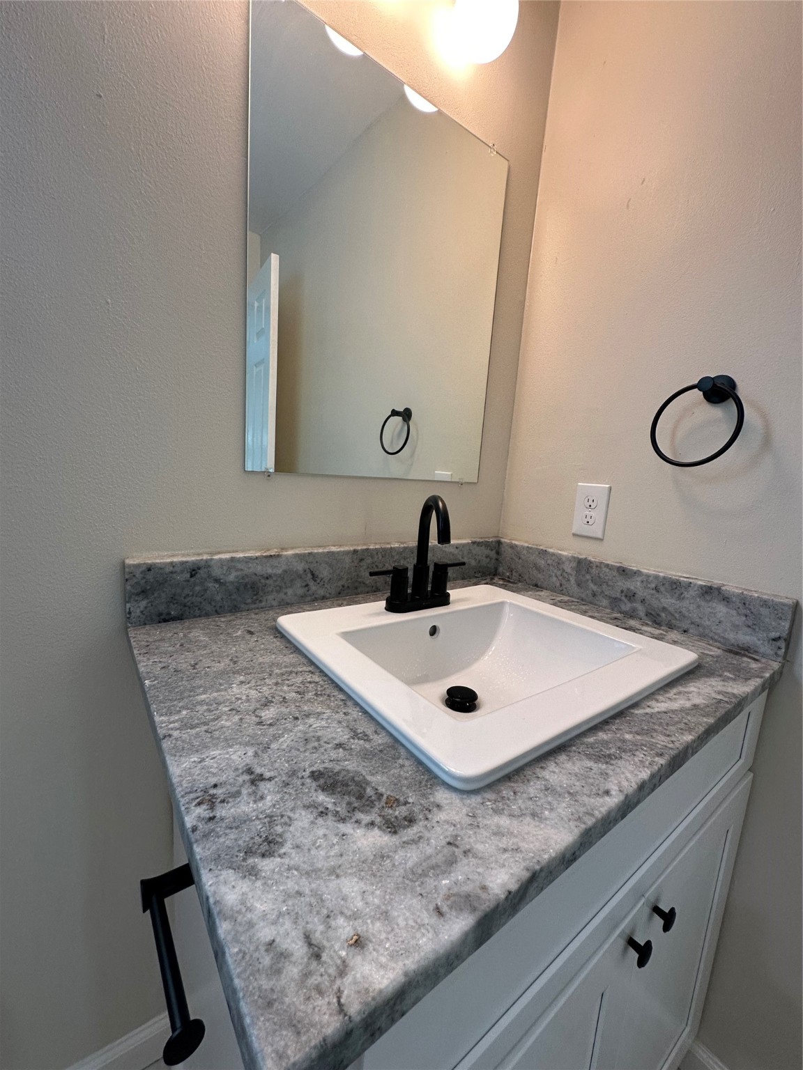 5910 East Houston Road Houston, TX 77028 - Photo 19 of 33 a bathroom with a granite countertop sink and a mirror