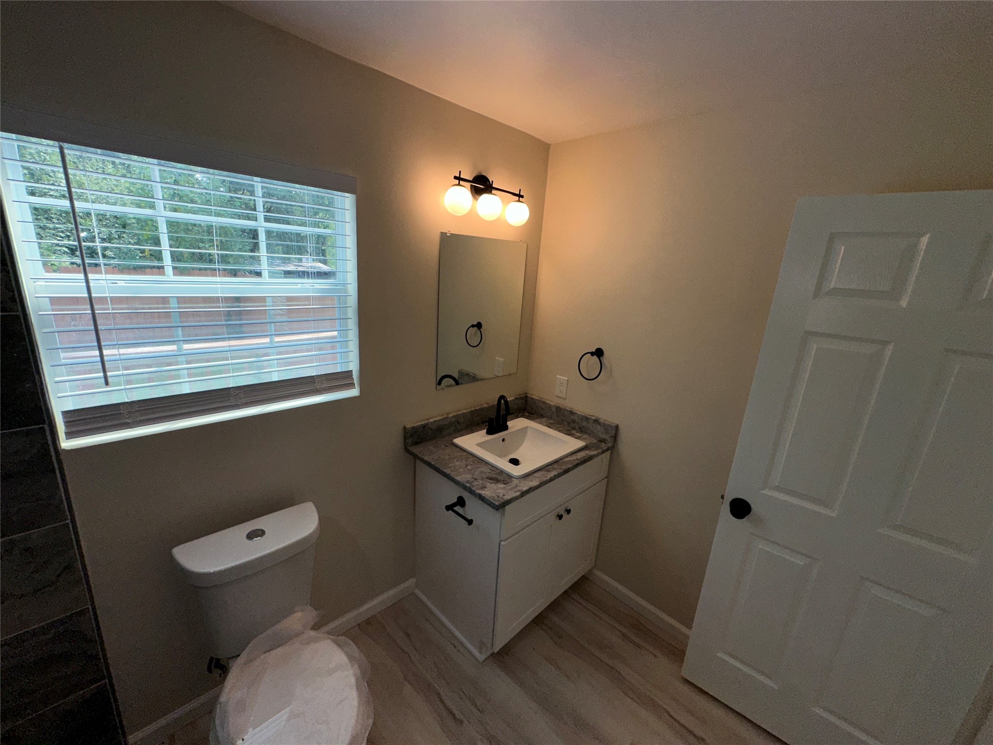 5910 East Houston Road Houston, TX 77028 - Photo 22 of 33 a bathroom with a toilet a sink and a mirror