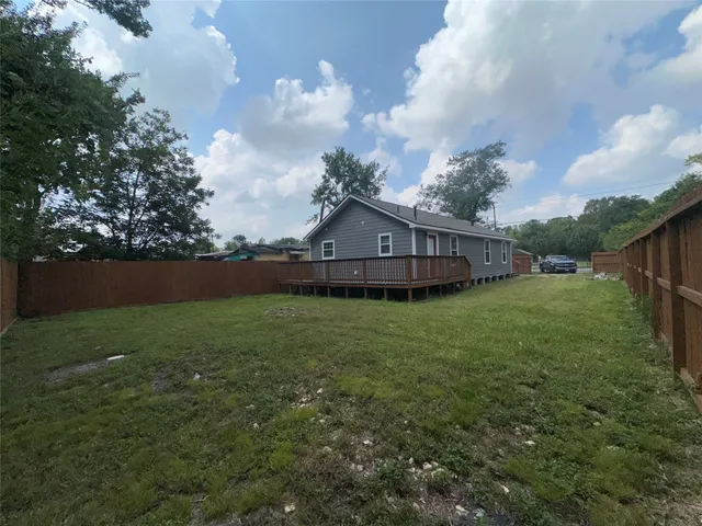 a view of house with backyard and garden