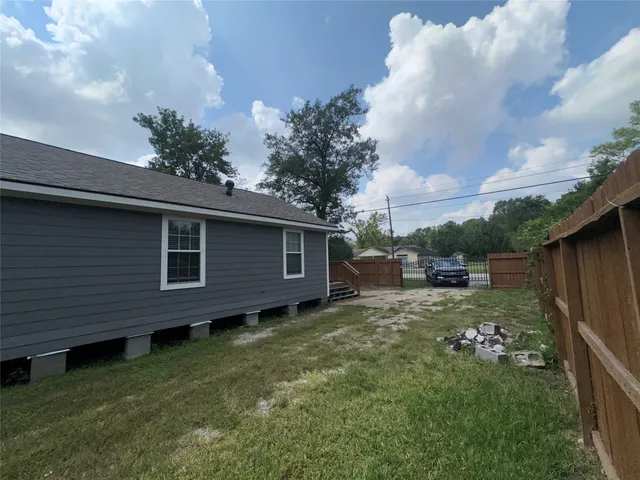 a view of a backyard with plants and a barbeque