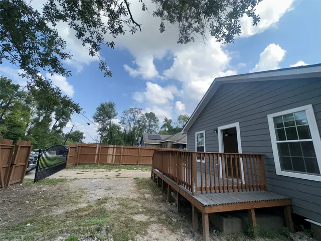 a view of backyard with deck and outdoor seating