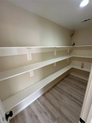 a hallway view with wooden floor