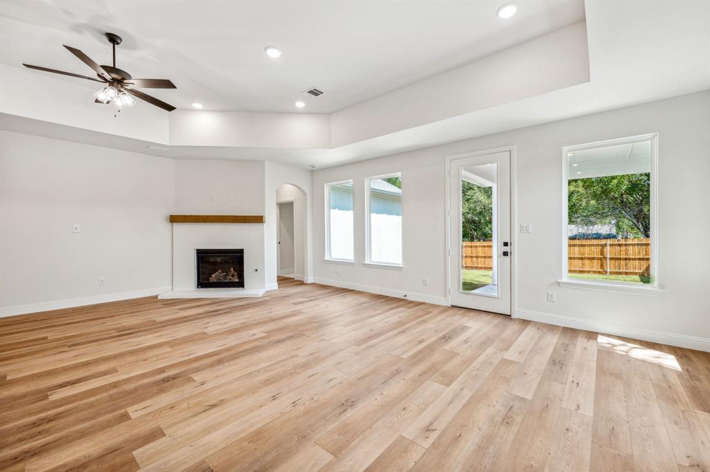 122 John Street Aledo, TX 76008 - Photo 12 of 33 a view of an empty room with wooden floor fireplace and a window