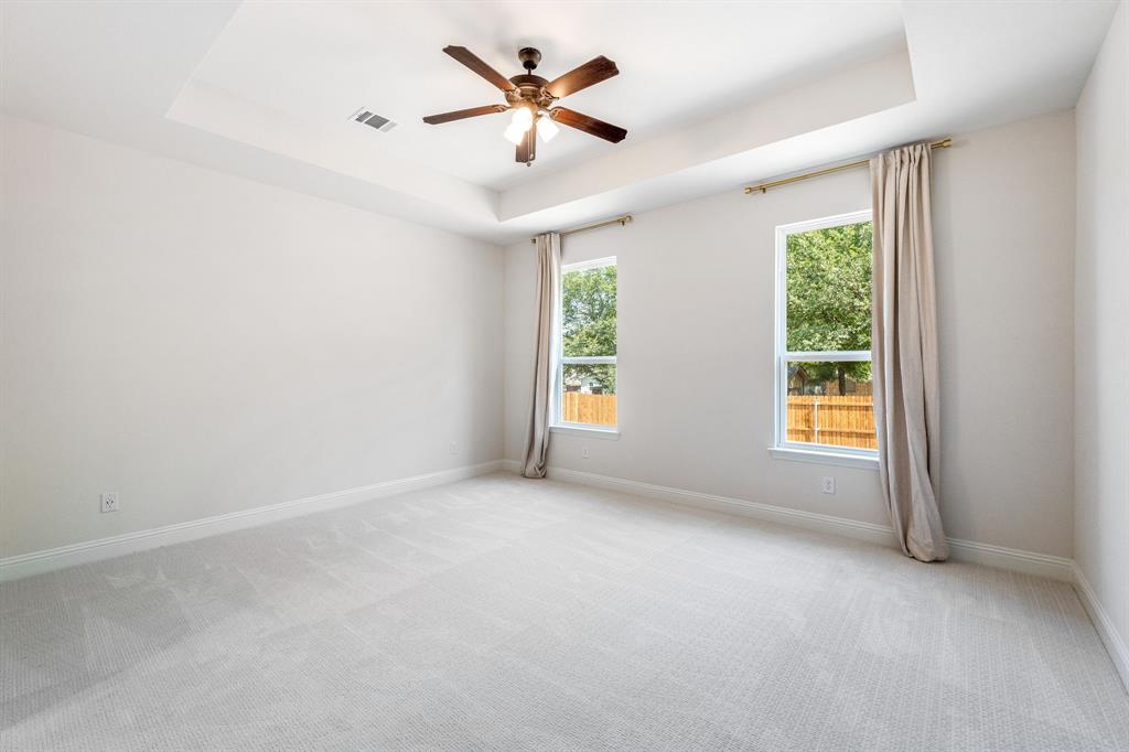 122 John Street Aledo, TX 76008 - Photo 14 of 33 an empty room with windows and chandelier fan