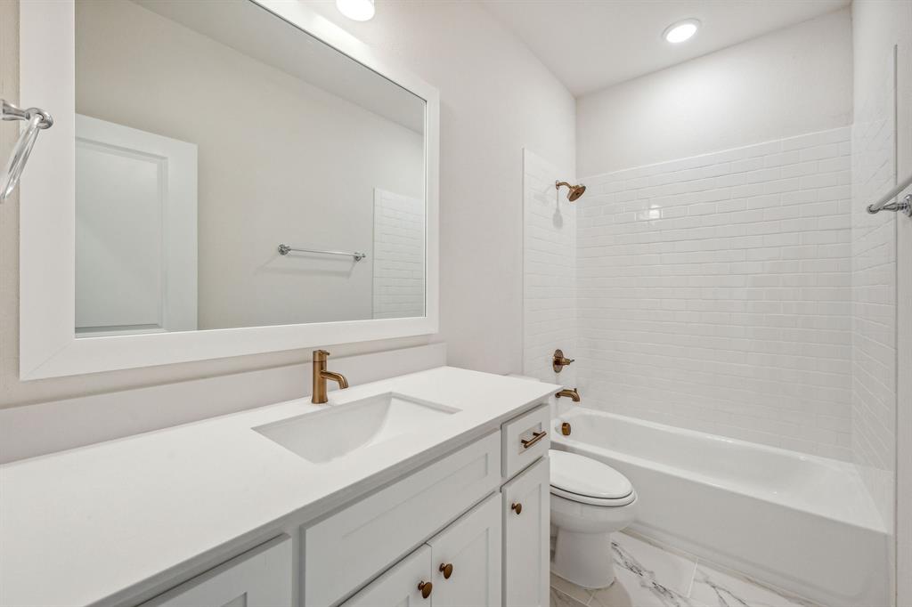 122 John Street Aledo, TX 76008 - Photo 19 of 33 a bathroom with a sink a toilet and shower