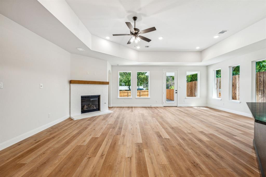 122 John Street Aledo, TX 76008 - Photo 2 of 33 a view of an empty room with wooden floor fireplace and a window
