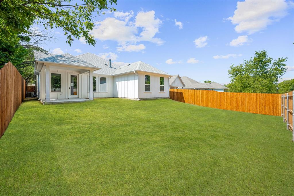 122 John Street Aledo, TX 76008 - Photo 25 of 33 a view of a house with a big yard and a large tree