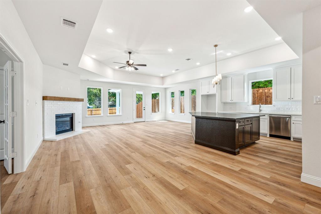 122 John Street Aledo, TX 76008 - Photo 27 of 33 a large kitchen with stainless steel appliances kitchen island a large counter top and a wooden floors