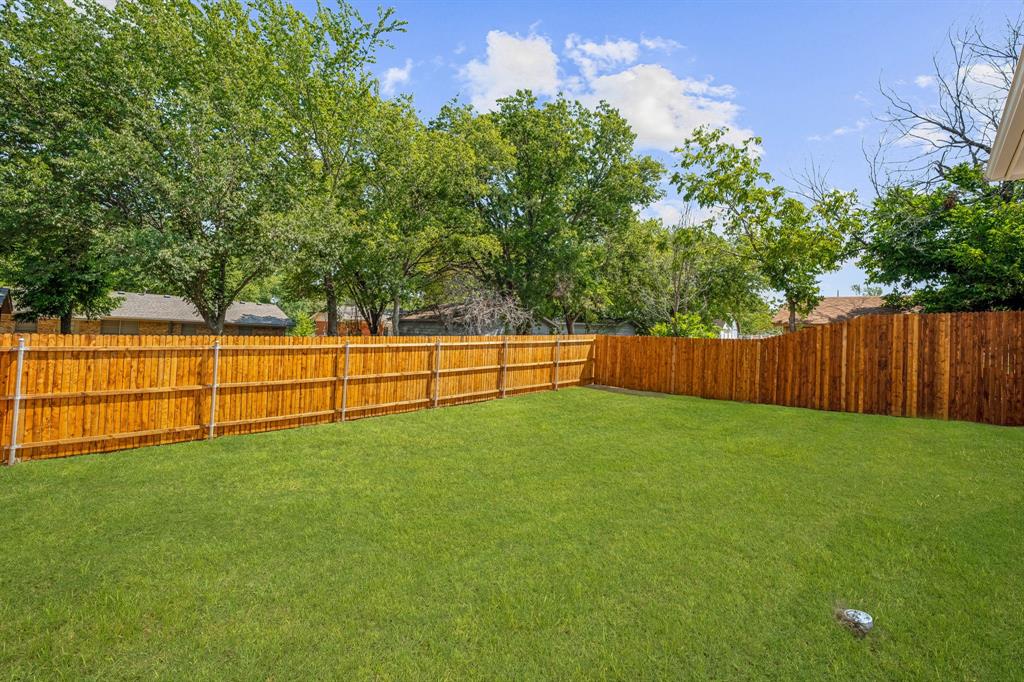 122 John Street Aledo, TX 76008 - Photo 6 of 33 a view of a backyard with large tree and wooden fence