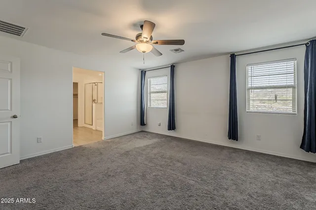 a kitchen with center island a sink stainless steel appliances and a window
