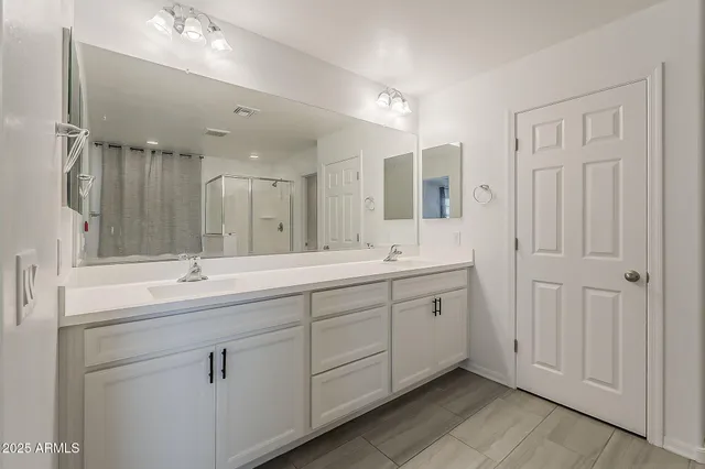 a kitchen with granite countertop kitchen island a sink stainless steel appliances and white cabinets