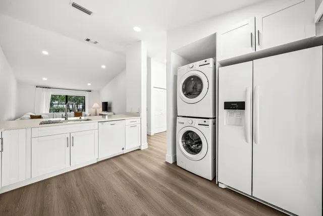 a kitchen with cabinets and washer