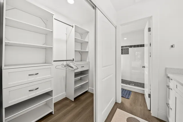 a view of walk in closet with empty racks