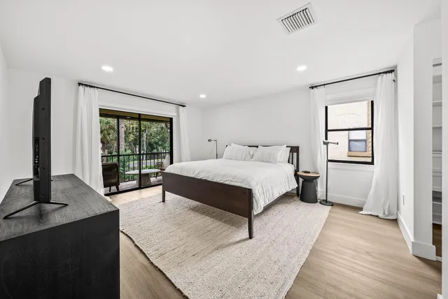 a bedroom with a large bed and a window