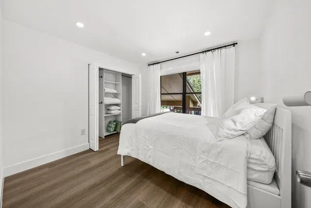 a bedroom with a bed and a window