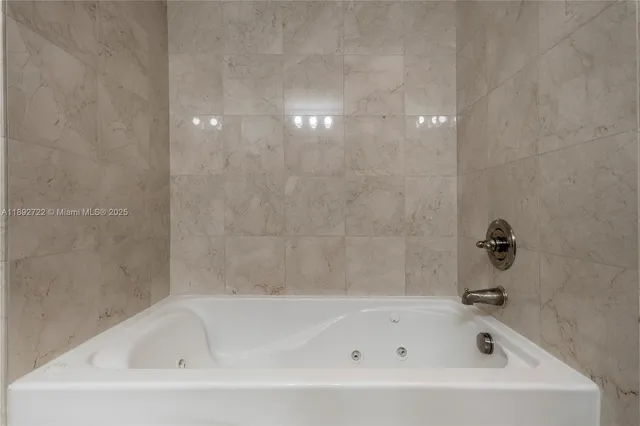 a bathroom with a bathtub and shower