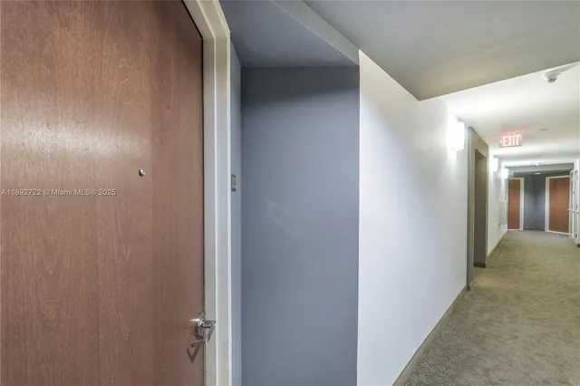 a room with pool table and windows