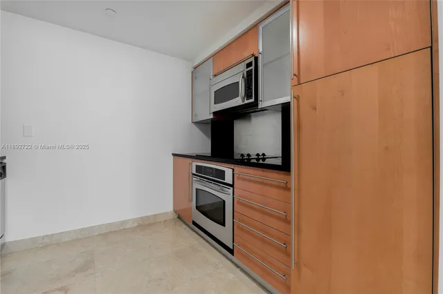 a kitchen with a microwave and cabinets