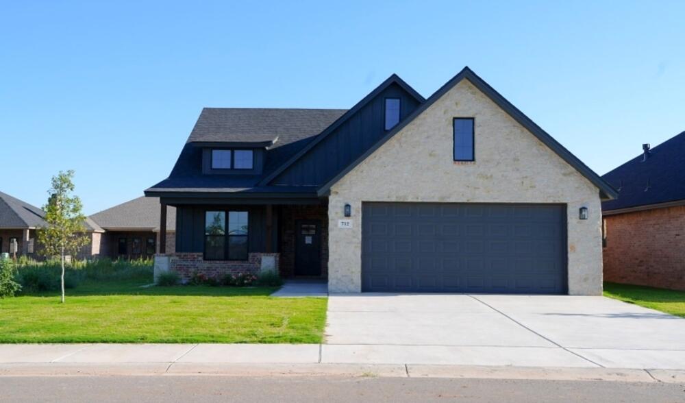 712 East 19th Street Wolfforth, TX 79382 - Photo 1 of 23 a front view of a house with a garden and plants