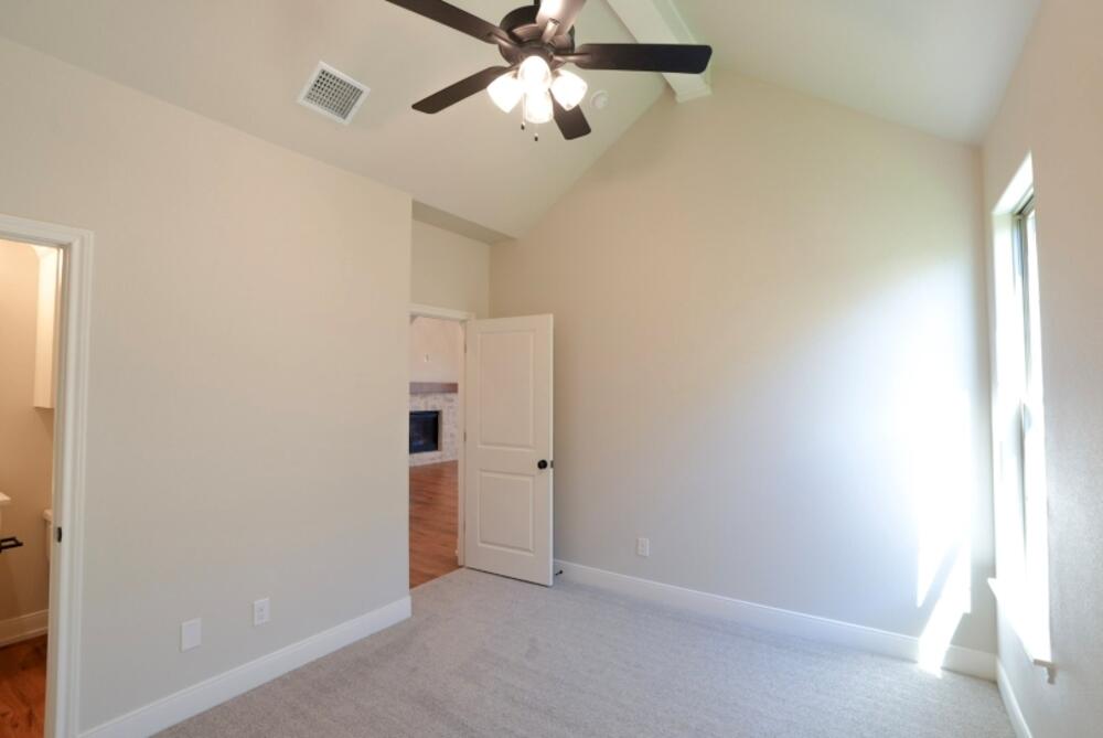 712 East 19th Street Wolfforth, TX 79382 - Photo 12 of 23 an empty room with closet and a chandelier fan