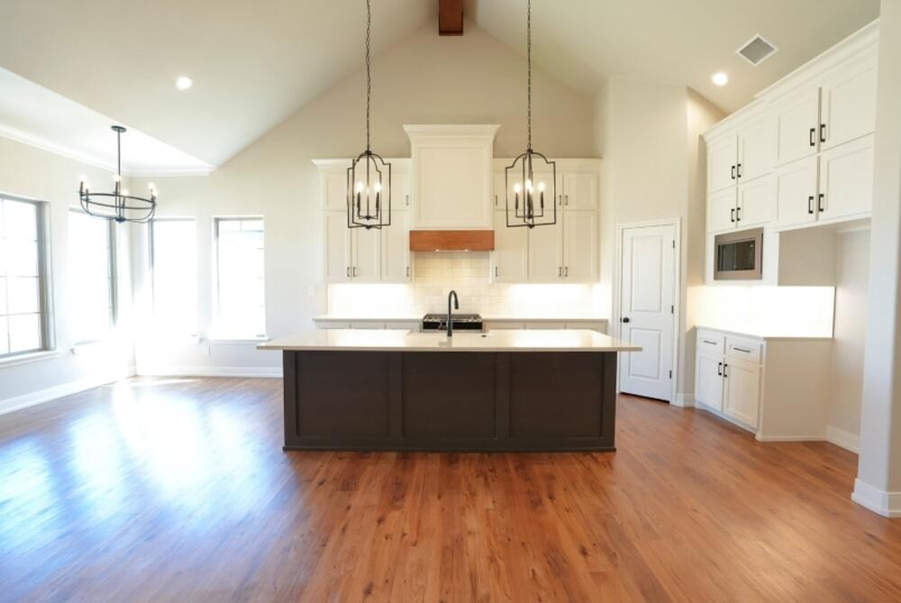 712 East 19th Street Wolfforth, TX 79382 - Photo 2 of 23 a room with wooden floors and kitchen view
