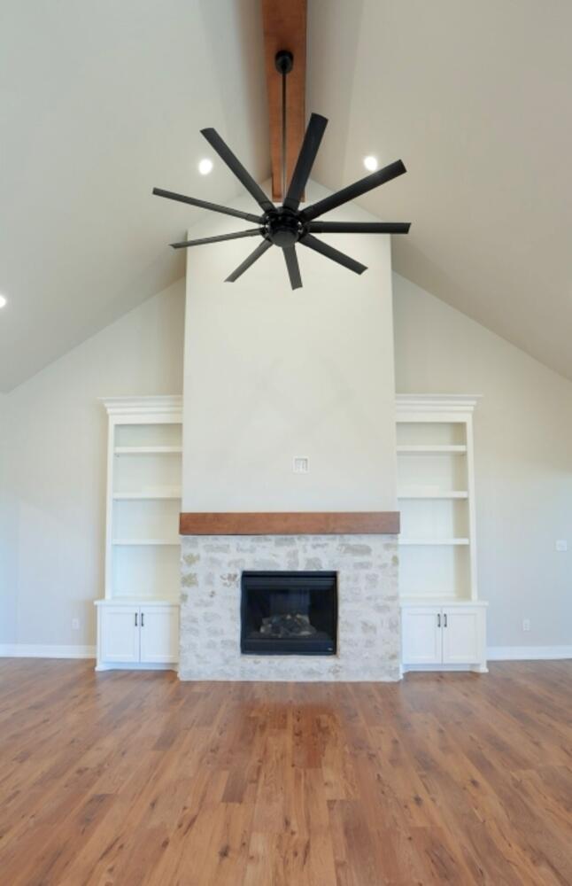 712 East 19th Street Wolfforth, TX 79382 - Photo 3 of 23 a view of empty room with a fireplace and a ceiling fan