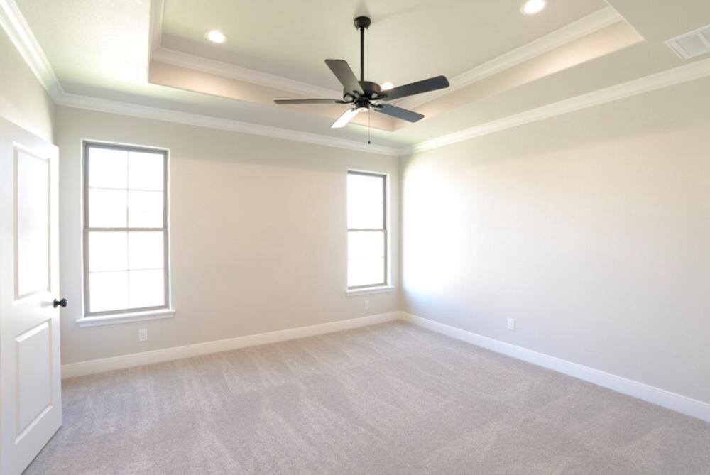 712 East 19th Street Wolfforth, TX 79382 - Photo 7 of 23 an empty room with a window and a fan