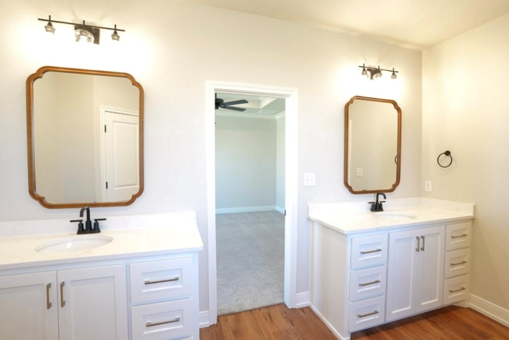 712 East 19th Street Wolfforth, TX 79382 - Photo 8 of 23 a bathroom with a double vanity sink and a mirror