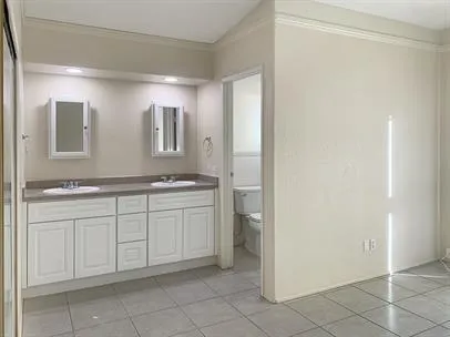 a spacious bathroom with a granite countertop sink and a mirror