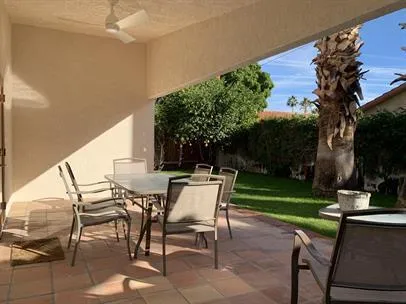 a patio with a yard table and chairs