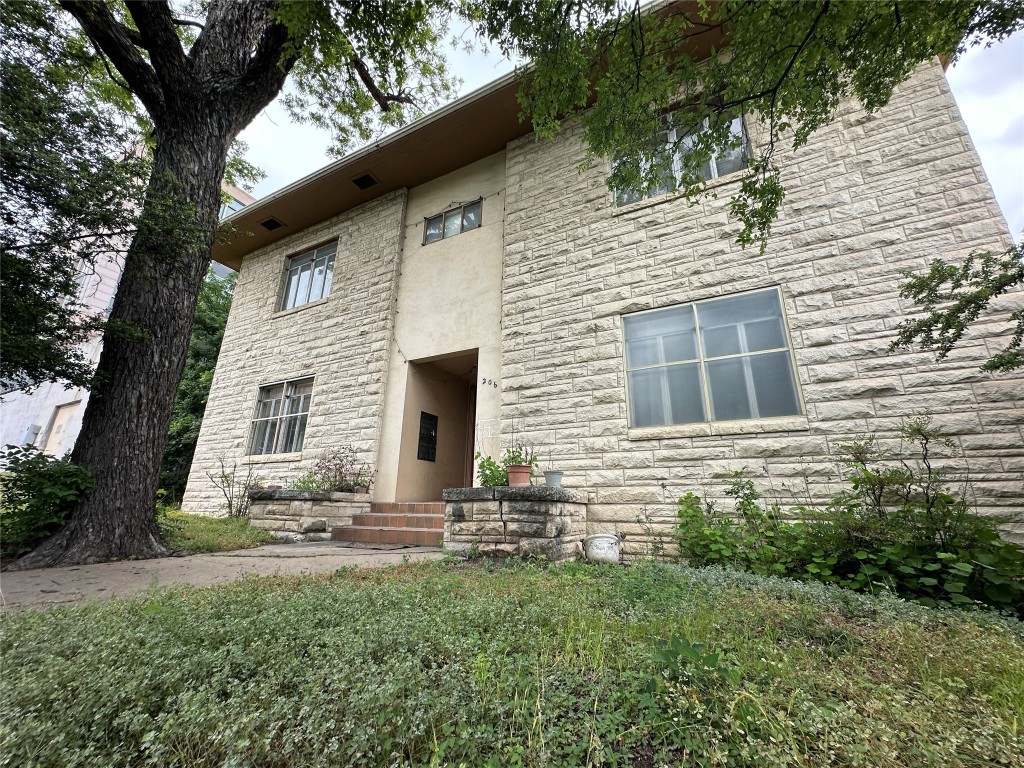 a view of house with backyard space and garden