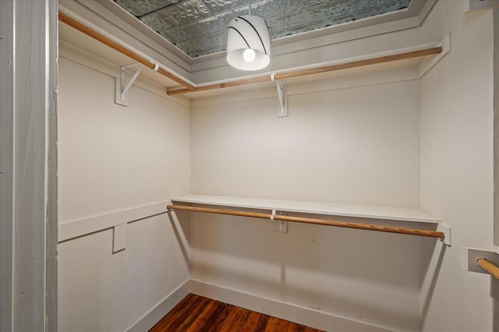 601 North Main Street Leonard, TX 75452 - Photo 18 of 34 Walk in closet featuring dark wood-style flooring