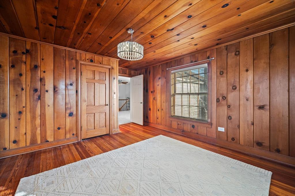 601 North Main Street Leonard, TX 75452 - Photo 24 of 34 Unfurnished bedroom featuring wood-type flooring, wooden ceiling, and wood walls