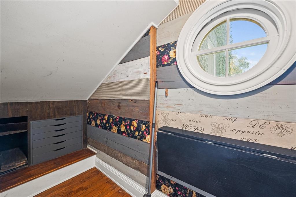601 North Main Street Leonard, TX 75452 - Photo 25 of 34 Bedroom featuring wooden walls, vaulted ceiling, and wood finished floors