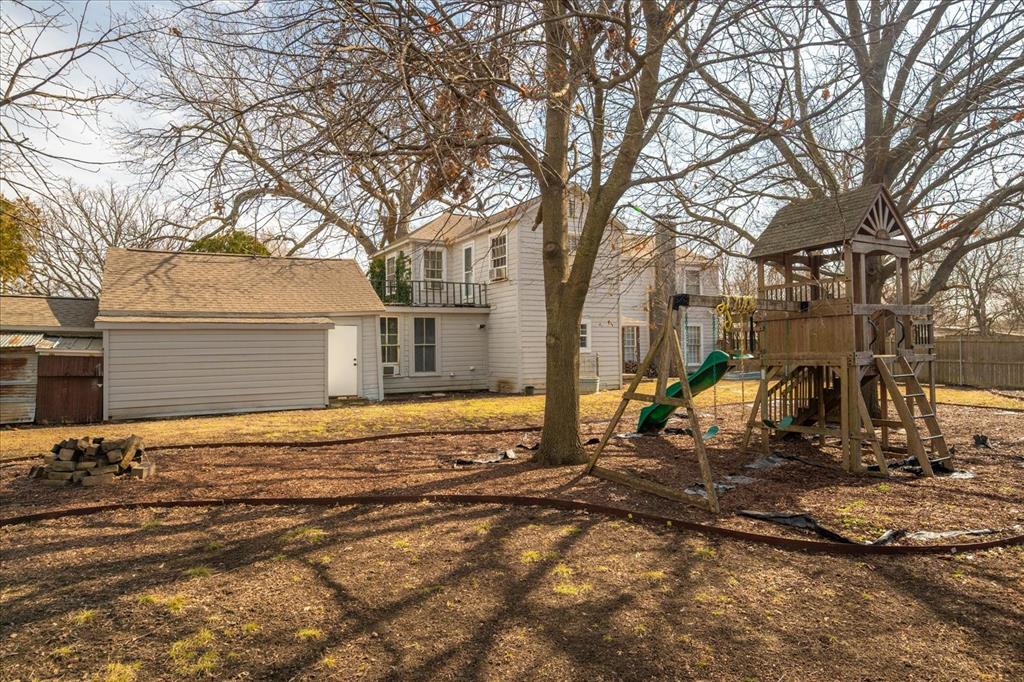 601 North Main Street Leonard, TX 75452 - Photo 30 of 34 Rear view of house with a playground