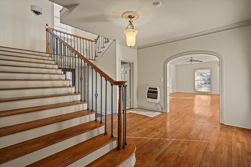 601 North Main Street Leonard, TX 75452 - Photo 6 of 34 Stairs featuring arched walkways, crown molding, wood finished floors, a ceiling fan, and heating unit