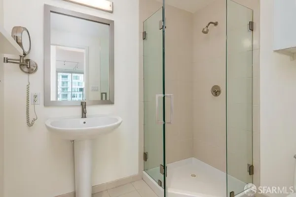 a bathroom with a sink a mirror and shower
