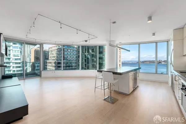 a view of workspace with furniture and large window