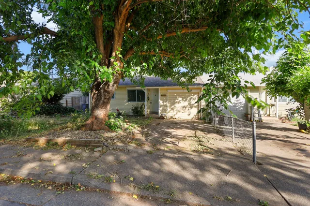 a view of a house with a tree in the background