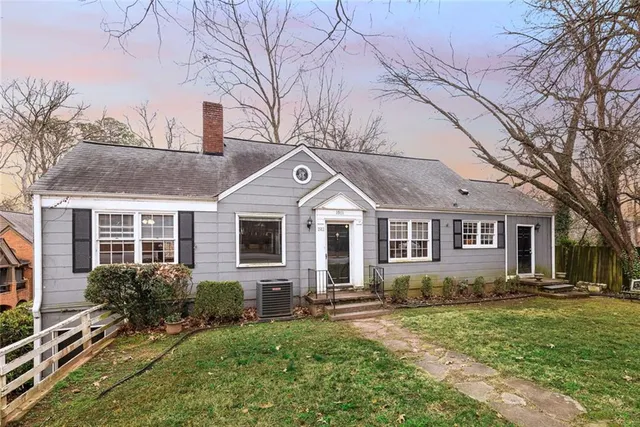 a front view of house with yard and green space