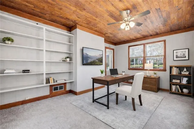 a workspace with furniture and a bookshelf