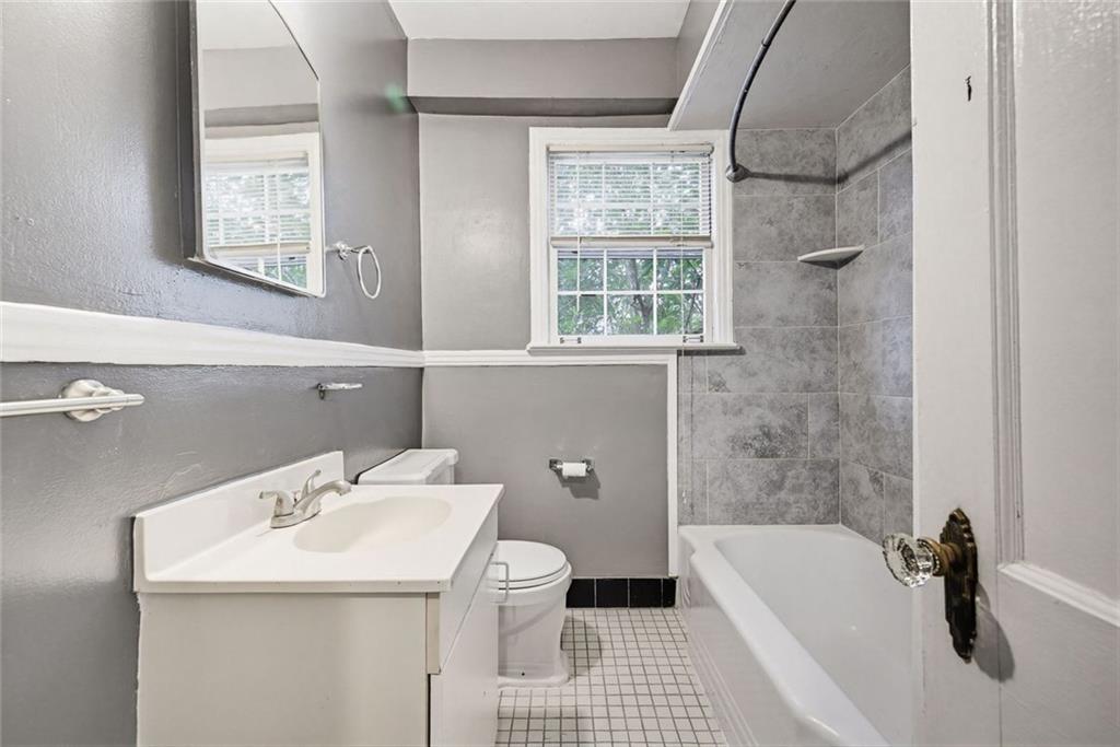 1911 North Decatur Road, Unit 2 Atlanta, GA 30307 - Photo 13 of 16 a bathroom with a sink a toilet and shower